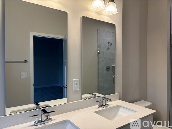 A bathroom with a sink, mirror, and shower.