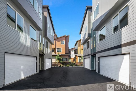 A row of modern houses with garages in front.