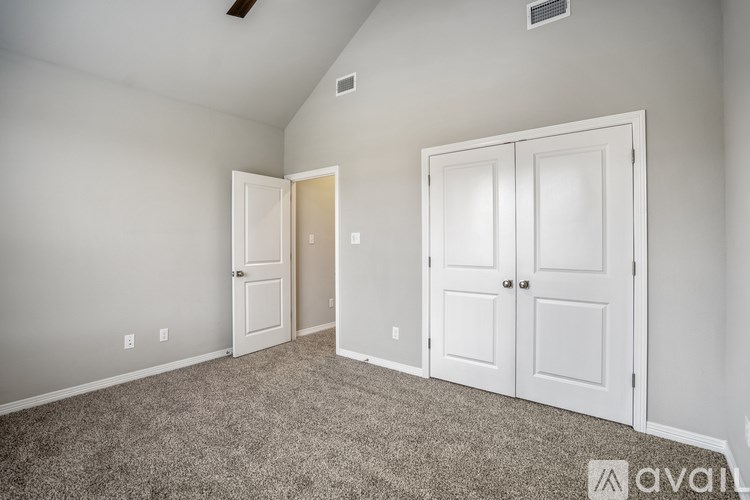 A room with two doors and a carpeted floor.