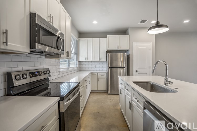 A kitchen with white cabinets and appliances.