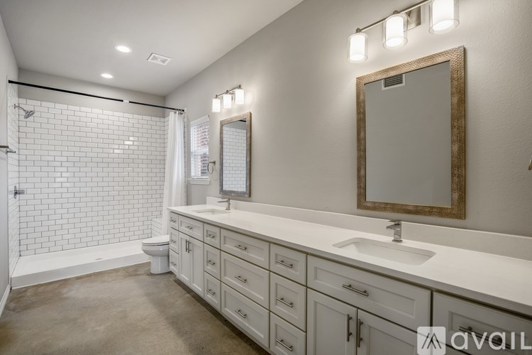 A bathroom with a white counter and a mirror above it.