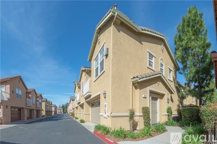 A row of houses with a clear blue sky above them.