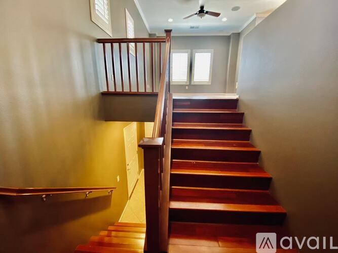 A staircase with wooden steps and a metal railing.