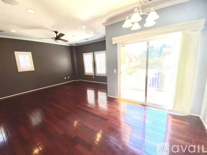 A room with brown walls and a ceiling fan.