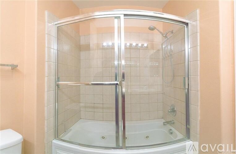 A pool area with a pergola and a pool in the middle.