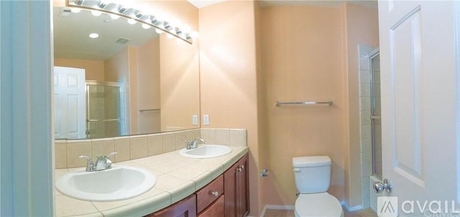 A playground with a blue slide and a yellow sign.