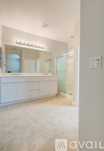 A bathroom with a vanity and a mirror.