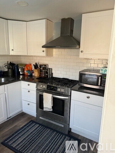 A kitchen with a stove top oven and a microwave.