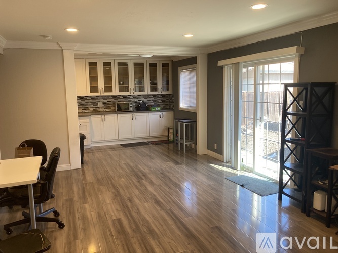 A kitchen with a dining table and chairs is available for rent.