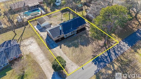 A bird's eye view of a property with a swimming pool and a covered patio.