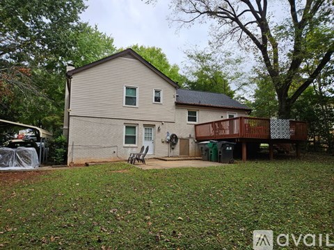 A house with a brown roof and a white fence.