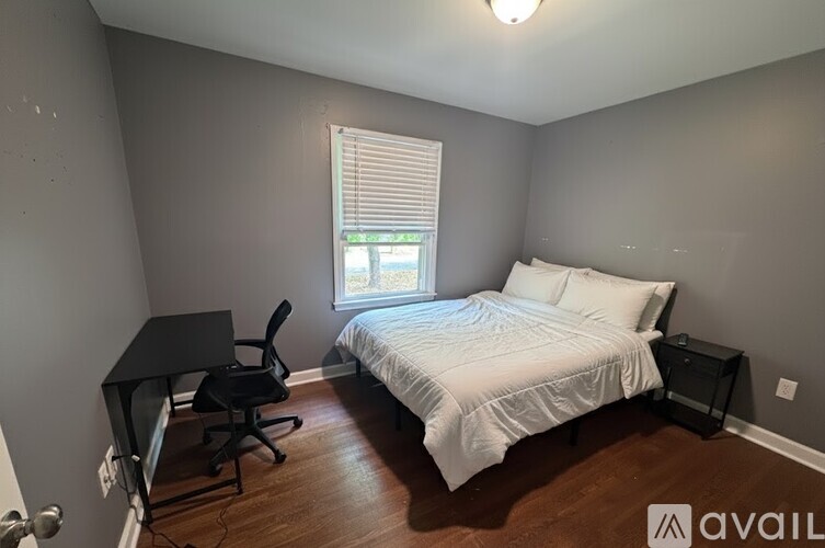 A kitchen with a stainless steel refrigerator, microwave, oven, and other appliances.