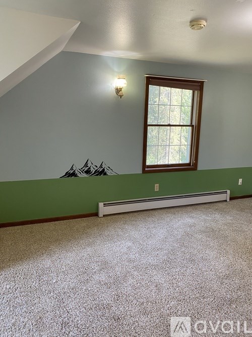 A room with a window and a bench.