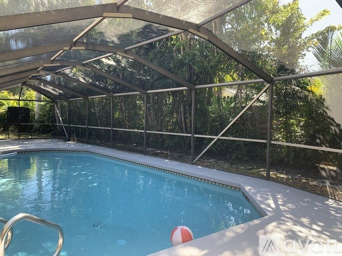 A pool with a red and white ball in the middle of it.