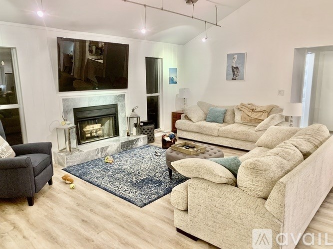 A living room with a fireplace and a large couch.
