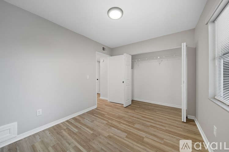 A room with a wooden floor and white walls.