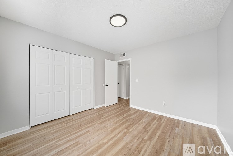 A room with a white door and a white wall.