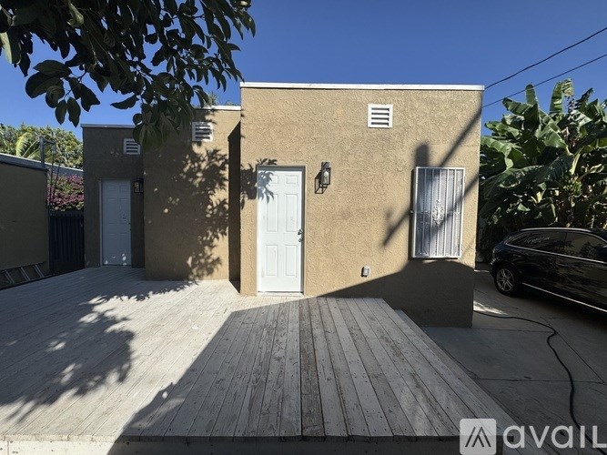 A house with a white door and a wooden deck.