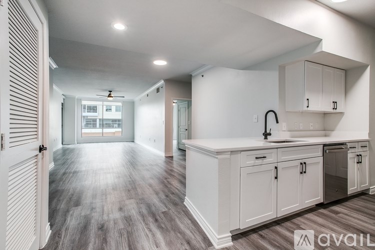 A kitchen with white cabinets and a sink.