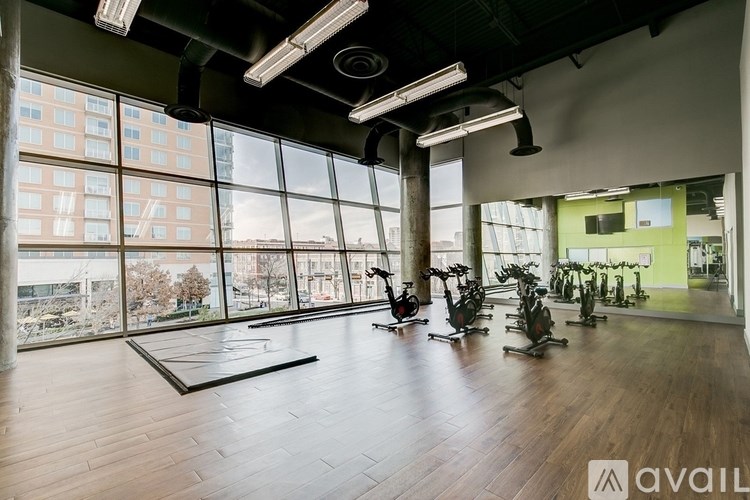 A gym with a view of the city outside the large windows.