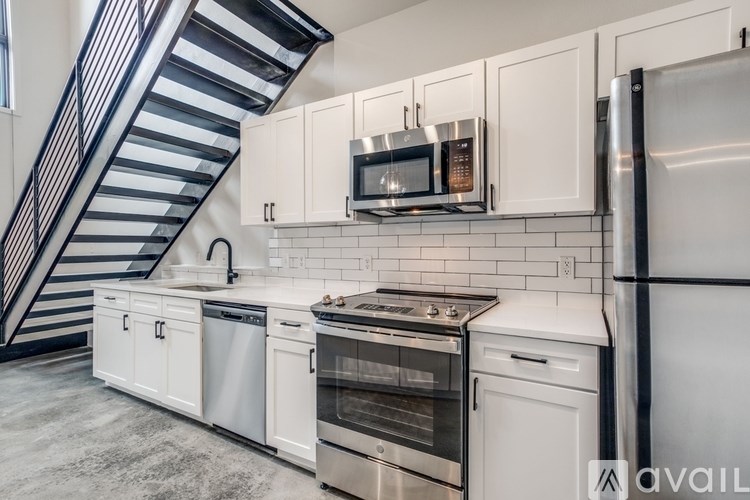 A kitchen with white cabinets and stainless steel appliances.