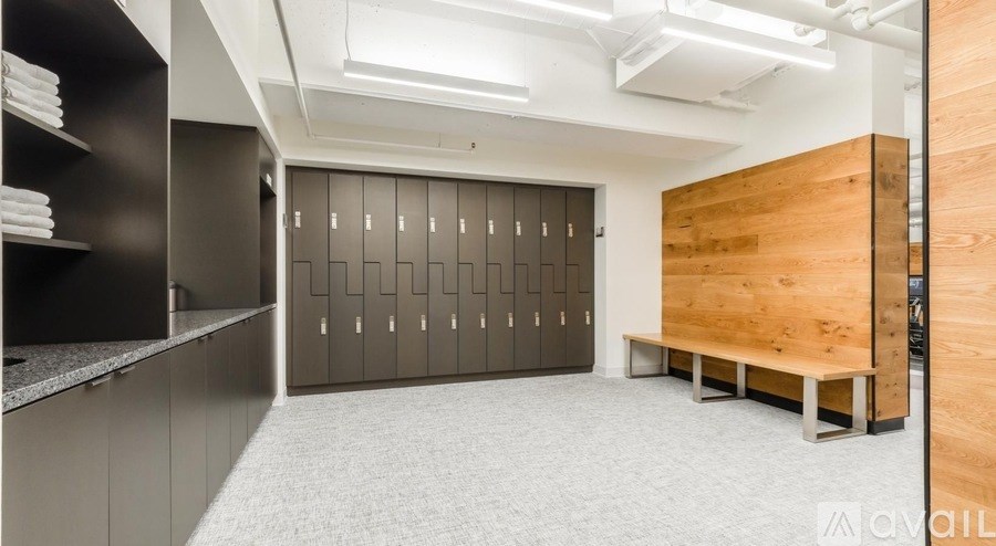 A room with a row of lockers and a bench.