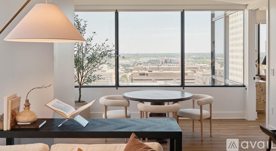 A living room with a large window overlooking a cityscape.