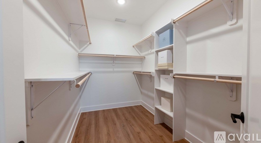 A white closet with shelves and a hanging rod.