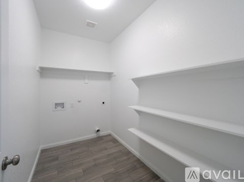 A room with a door, a wall, and a floor.