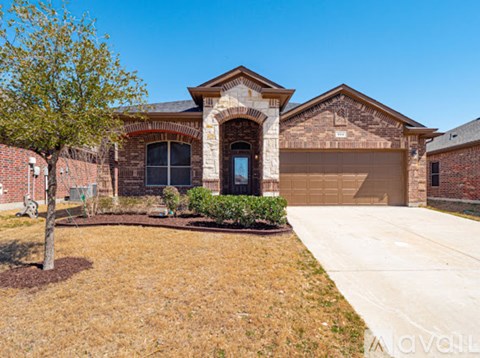 A house with a brick facade and a large front yard.