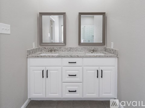 A bathroom vanity with two mirrors above it.