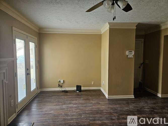 A room with a ceiling fan and a speaker on the floor.