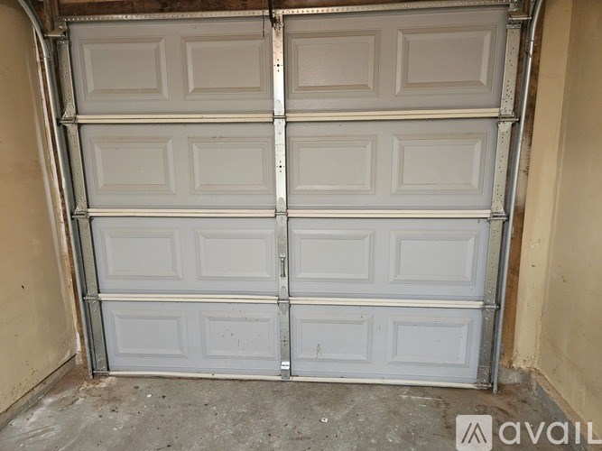 A white double garage door with a metal frame.