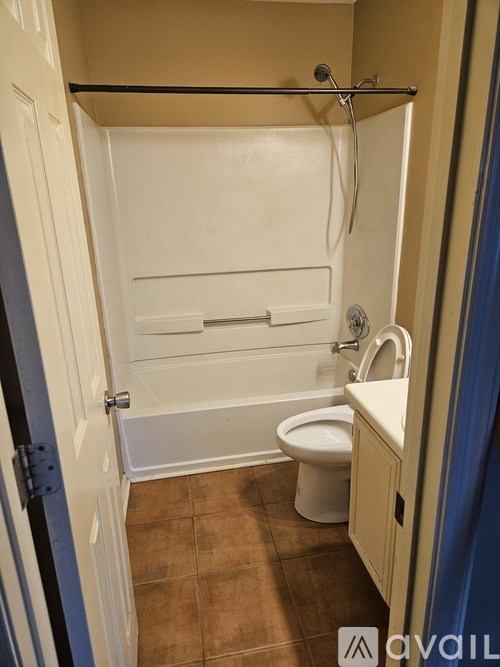 A bathroom with a toilet, sink, and bathtub.