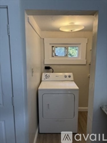 A small laundry room with a washer and dryer.