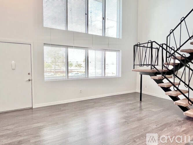 A room with a staircase and a door.