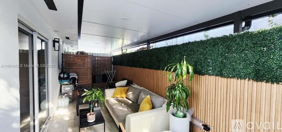 A living room with a couch, a coffee table, and a green wall.