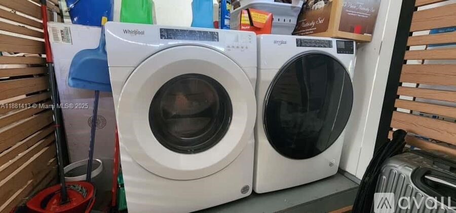Two washing machines are on a shelf.