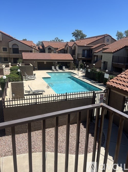 A pool in a backyard surrounded by houses.