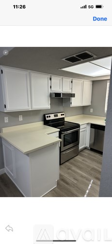 A bathroom with a toilet, sink, and mirror.