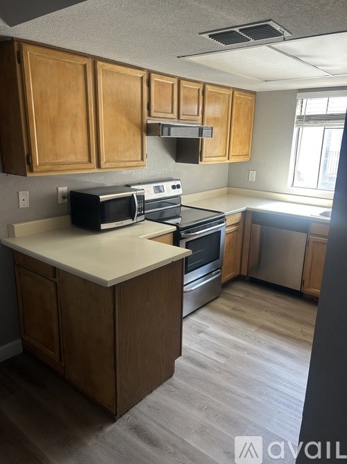 A kitchen with wooden cabinets and stainless steel appliances.