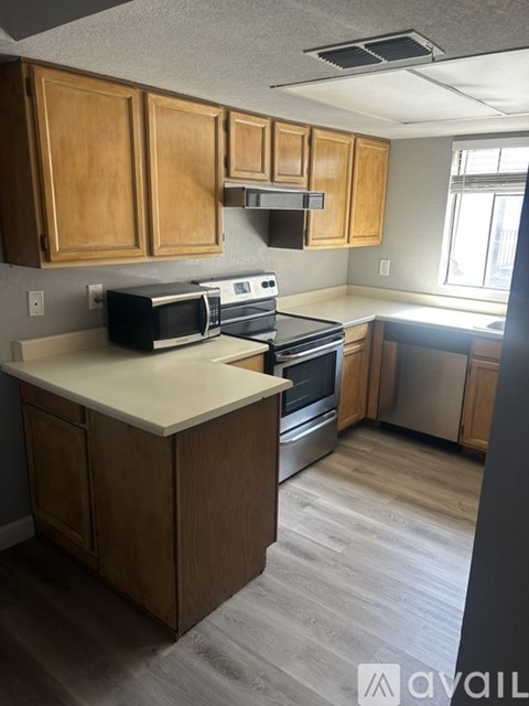 A kitchen with wooden cabinets and stainless steel appliances.