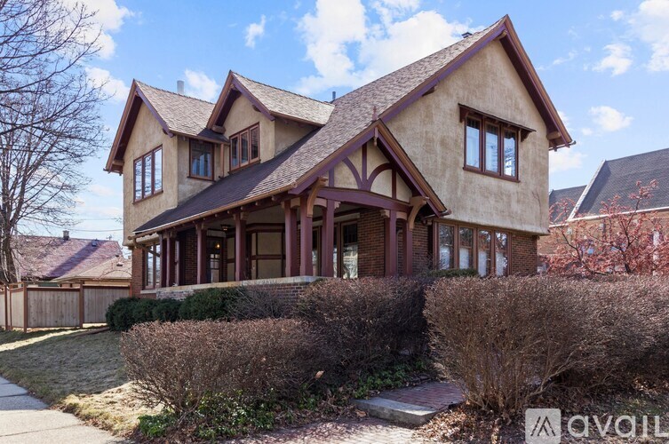 A house with a brown roof and a large front yard.