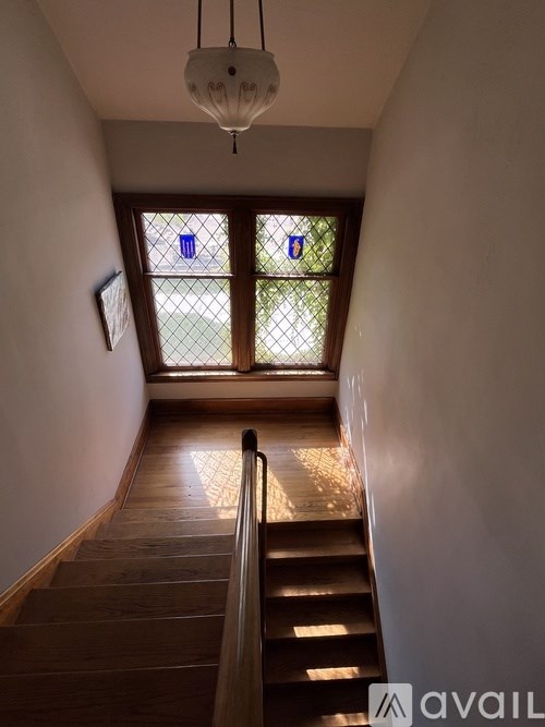 A staircase with a light hanging above it.