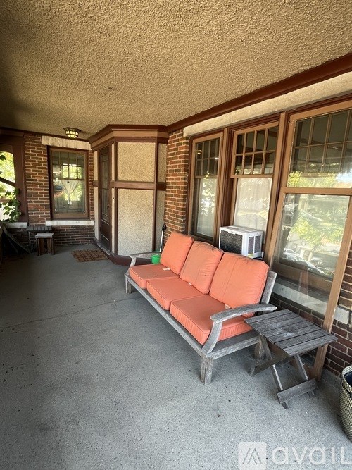 A patio with a couch and a table.
