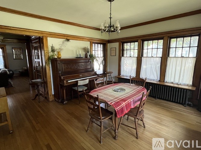 A room with a piano and a table set for a meal.