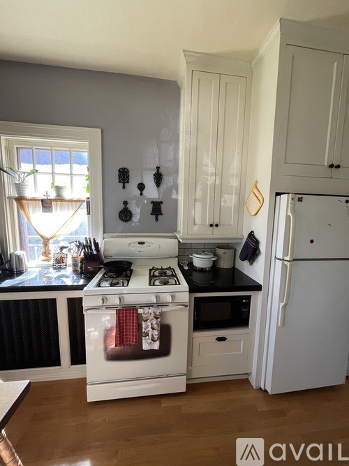 A kitchen with a stove, oven, and refrigerator.