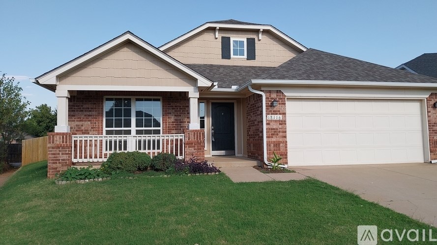 A house with a beige roof and a white garage door.