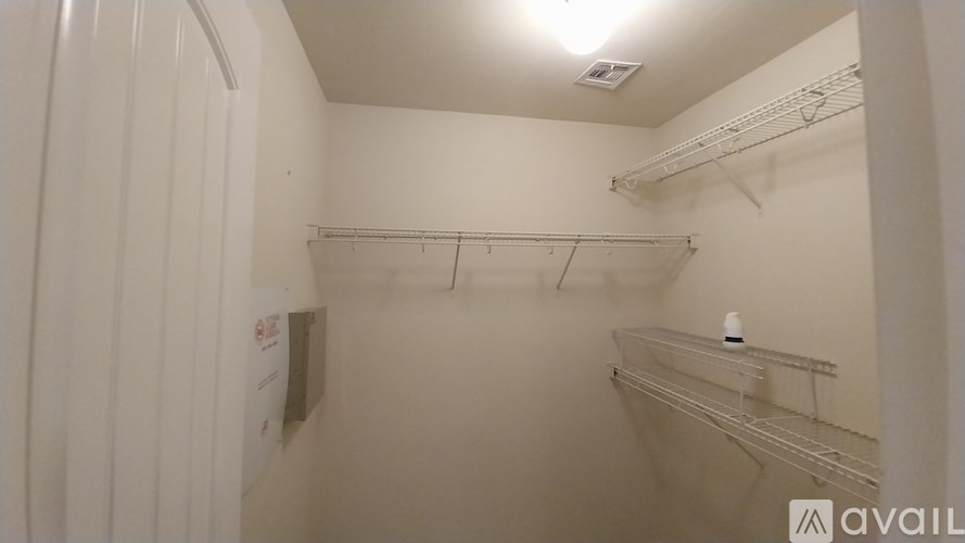 A small walk in closet with a white background.