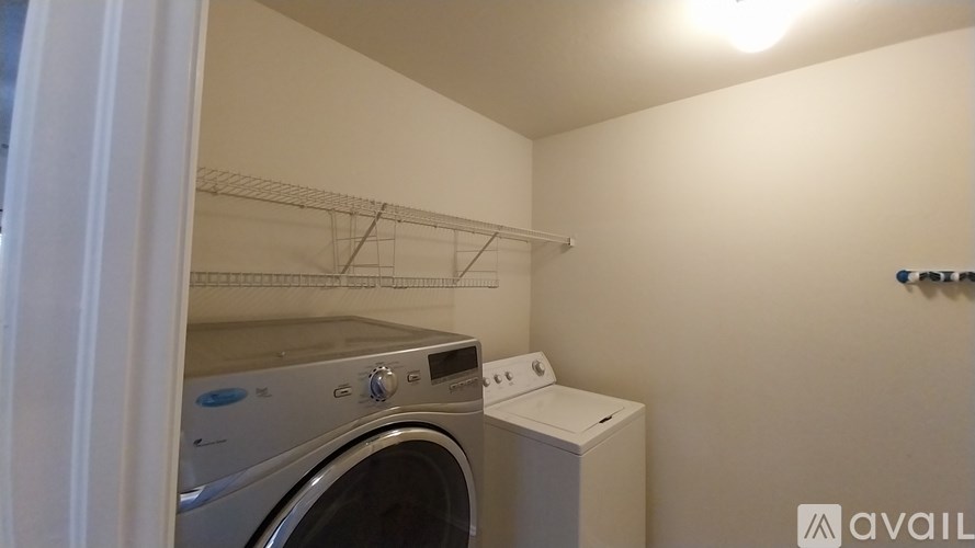 A small laundry room with a washer and dryer.